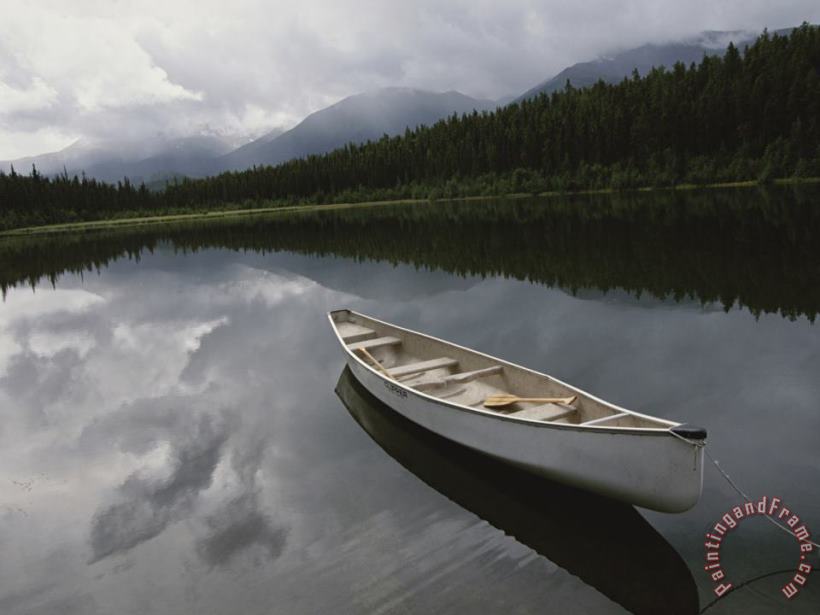 Raymond Gehman A Canoe Sits Tethered to Shore on a Beautiful Mountain Lake Art Print