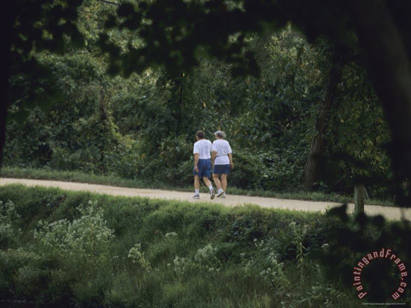 A Couple Walks on The Towpath of The Chesapeake And Ohio Canal painting - Raymond Gehman A Couple Walks on The Towpath of The Chesapeake And Ohio Canal Art Print