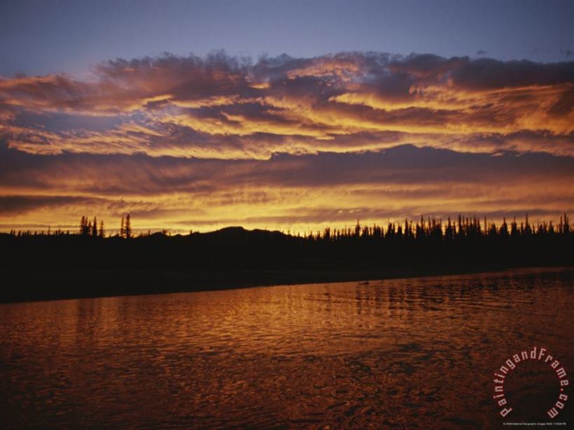 Raymond Gehman An Intense Sunset Colors Clouds And The Water of The Mackenzie River Art Painting