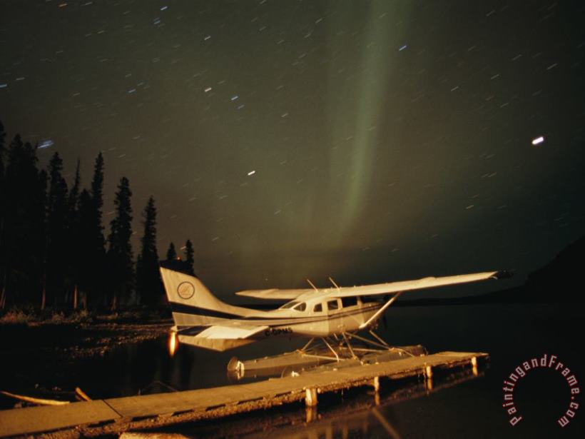 Raymond Gehman The Aurora Borealis Glows Brightly Over a Seaplane Docked on Cli Lake Art Print