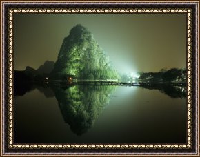 Pinocchio Wishes Upon a Star Framed Paintings - A Large Rock Formation Or Mountain on Shore of Star Lake at Night by Raymond Gehman