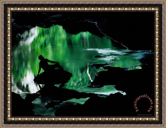 Raymond Gehman A Man Is Silhouetted Against an Emerald Green Pool of Water Framed Painting