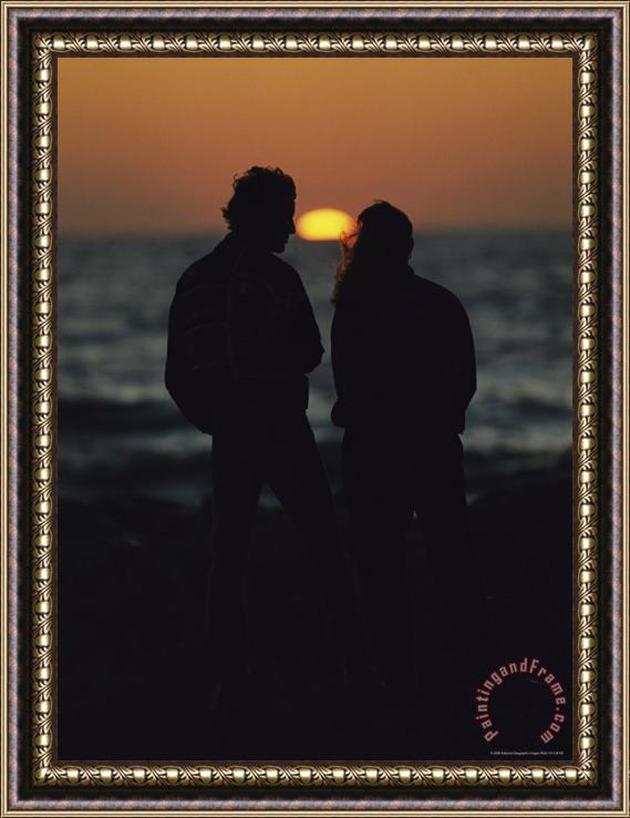 Raymond Gehman A Silhouetted Couple Watching The Sunset at Blind Pass Framed Print