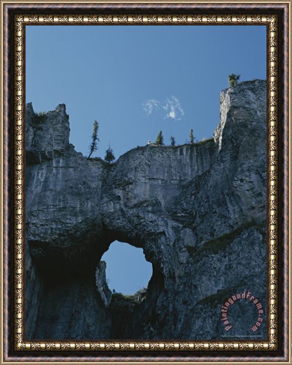 Raymond Gehman Erosion Carves a Window Into Limestone Rock in Nahanni National Park Framed Print