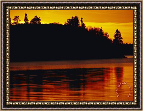Raymond Gehman The Setting Sun Casts an Orange Glow Over Manitoba S White Lake Framed Painting