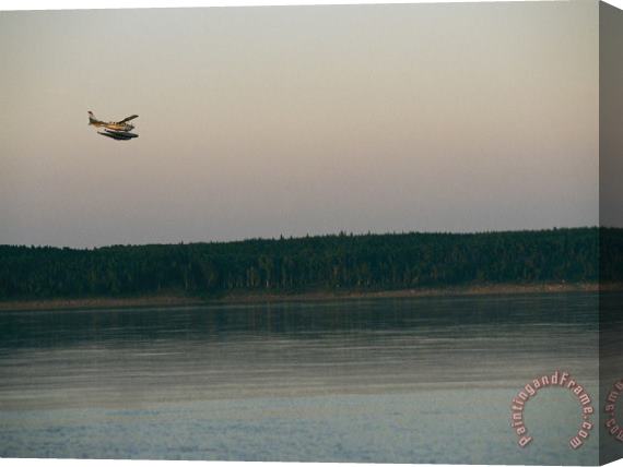 Raymond Gehman A Seaplane Soars Above The Mackenzie River at Dusk Stretched Canvas Print / Canvas Art