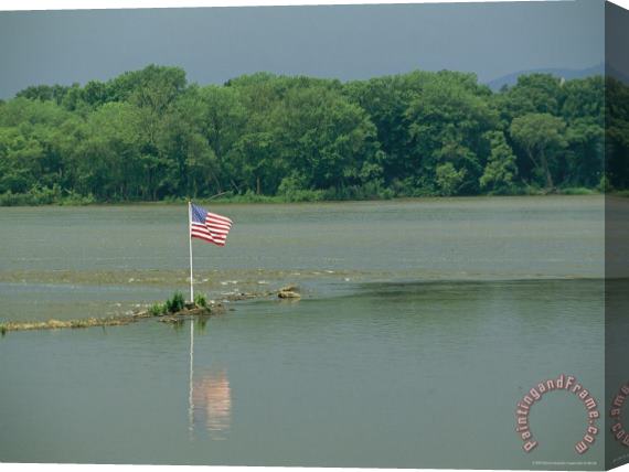 Raymond Gehman An American Flag Marks a Rock Outcrop Near a Ferry Crossing Stretched Canvas Print / Canvas Art