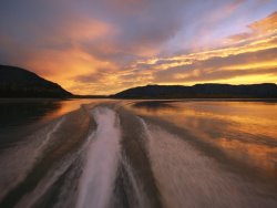 Raymond Gehman A Jet Boat Leaves a Wake in The Mackenzie River at Sunset