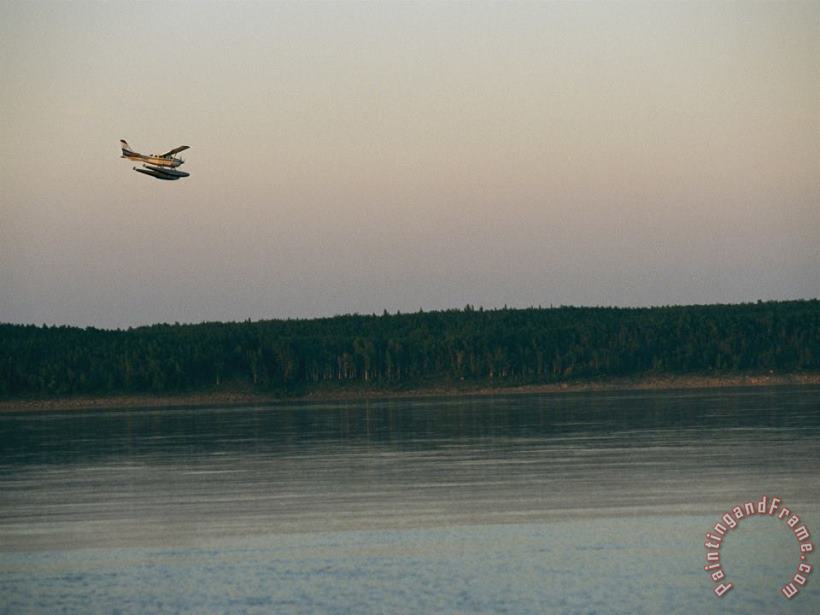 A Seaplane Soars Above The Mackenzie River at Dusk painting - Raymond Gehman A Seaplane Soars Above The Mackenzie River at Dusk Art Print