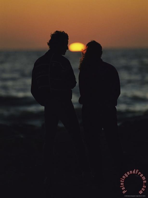 Raymond Gehman A Silhouetted Couple Watching The Sunset at Blind Pass Art Print