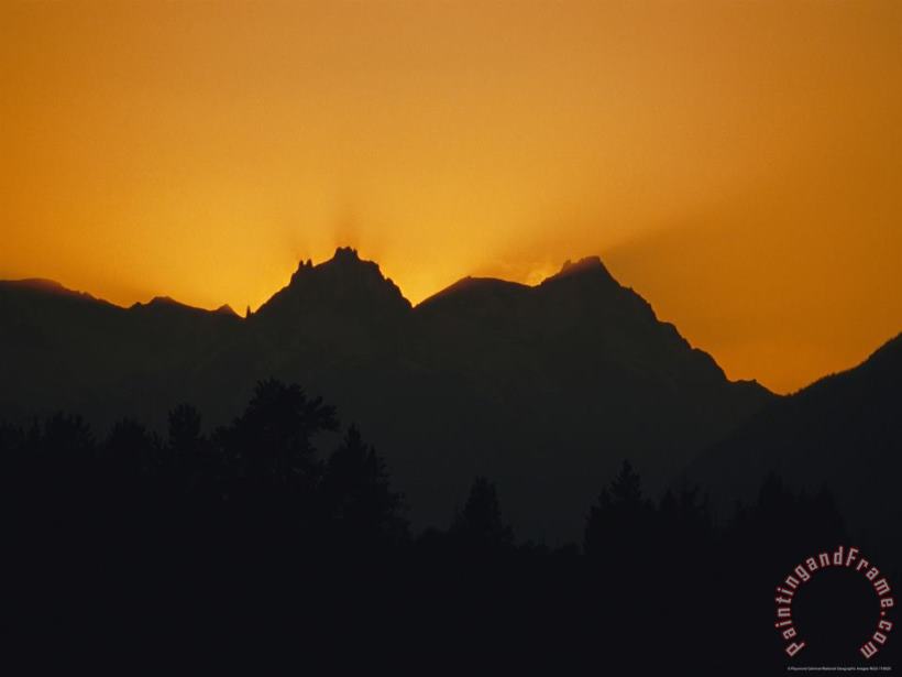 Mountain Peaks Appear in Silhouette at Twilight painting - Raymond Gehman Mountain Peaks Appear in Silhouette at Twilight Art Print