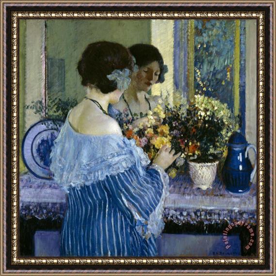 Frederick Carl Frieseke Girl in Blue Arranging Flowers Framed Print