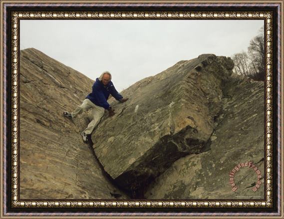 Raymond Gehman A Hiker Descends a Rock Formation on Great Falls Billy Goat Trail Framed Print