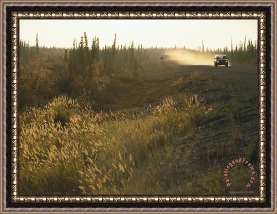 Raymond Gehman A Lone Vehicle Drives Down The Open Road of The Mackenize Highway Framed Painting