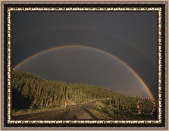 Raymond Gehman A Rainbow Arches Over The Alaska Highway in British Columbia Canada Framed Print