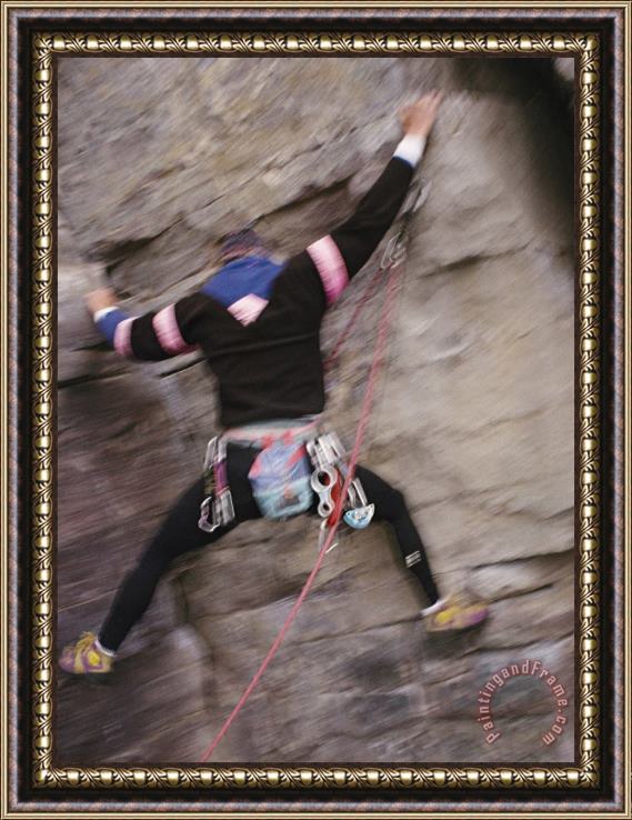Raymond Gehman A Rock Climber Clings to The Side of a Cliff Framed Print