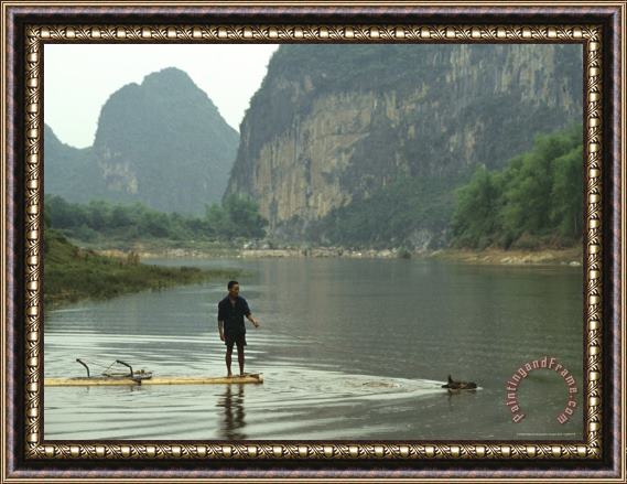Raymond Gehman A Water Buffalo Pulls a Farmer on Bamboo Raft Across Mingjiang River Framed Print