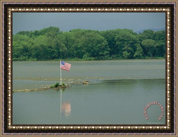 Raymond Gehman An American Flag Marks a Rock Outcrop Near a Ferry Crossing Framed Print