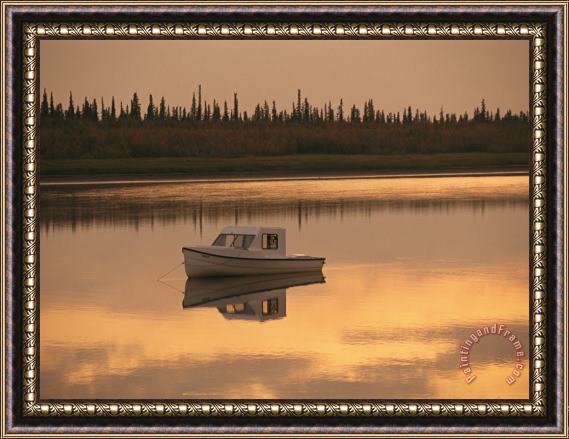 Raymond Gehman An Anchored Boat Floats on The Mackenzie River at Sunset Framed Print