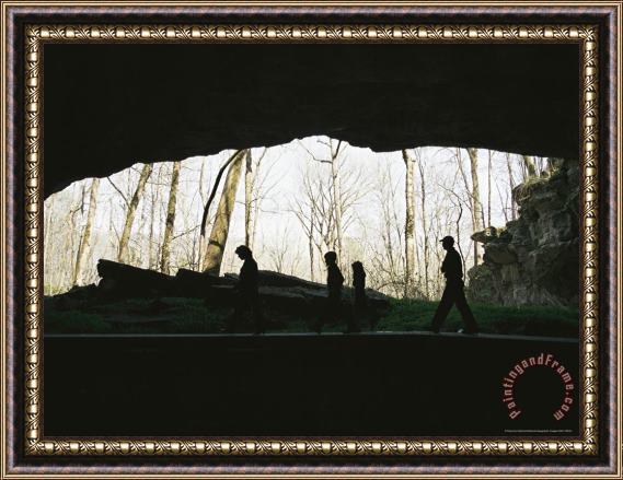 Raymond Gehman Family of Hikers Silhouetted in Front of a Cave Entrance Framed Print