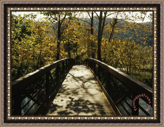 Raymond Gehman Footbridge Over Waterway in Autumn Hued Woods in a Mountain Valley Framed Print