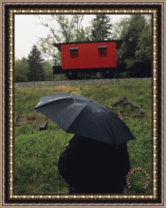 Raymond Gehman Person Under an Umbrella Looking at a Parked Train Caboose Framed Painting