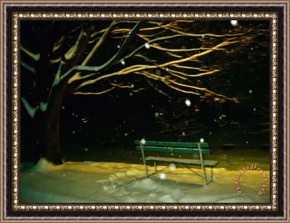 Raymond Gehman Snow Falls on a Park Bench at Night Framed Print