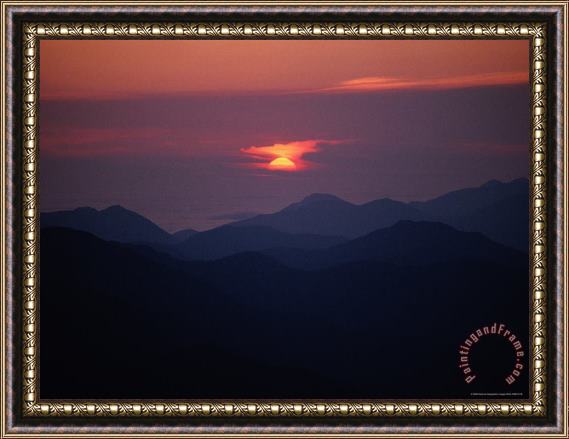 Raymond Gehman Sunrise Over a Silhouetted Range of Mountains Framed Painting