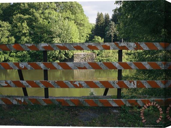 Raymond Gehman A Barricade Blocks The Road Where a Bridge Once Crossed The River Stretched Canvas Print / Canvas Art
