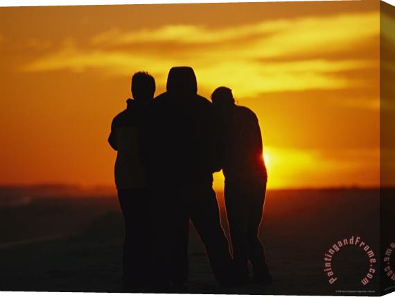Raymond Gehman A Silhouetted Family Watches a Dramatic Sunset Stretched Canvas Painting / Canvas Art
