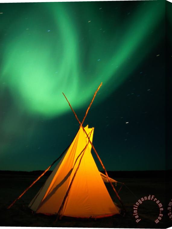 Raymond Gehman A Solitary Tepee Is Illuminated by The Aurora Borealis Stretched Canvas Print / Canvas Art