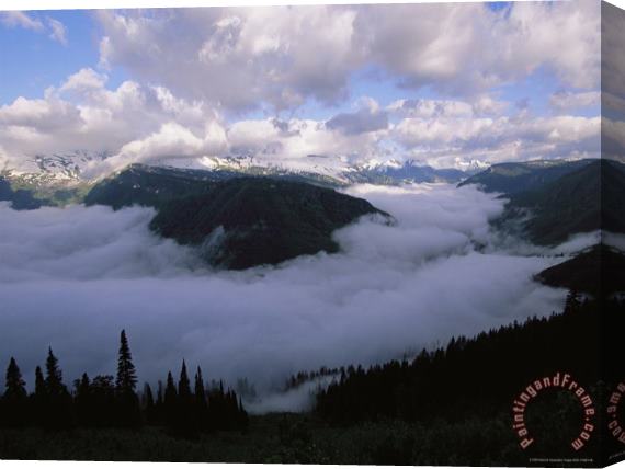 Raymond Gehman Clouds Shroud The Valley And Fill The Sky Along Logan Pass Stretched Canvas Print / Canvas Art