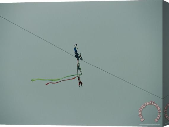 Raymond Gehman High Wire Acrobats Performing Feats of Daring Using a Small Bicycle Stretched Canvas Print / Canvas Art