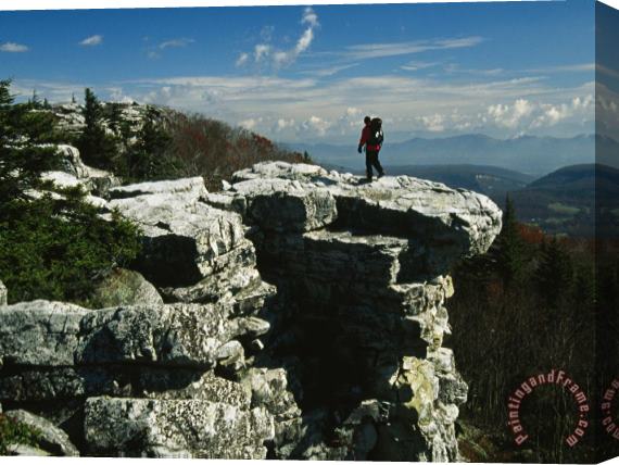 Raymond Gehman Hiker Standing at The Edge of a Rock Outcrop on a Mountain Stretched Canvas Print / Canvas Art