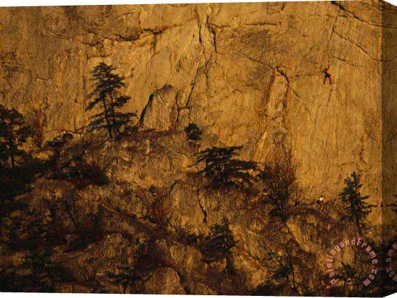 Raymond Gehman Rock Outcrop with Sheer Cliffs And Silhouetted Evergreen Trees Stretched Canvas Painting / Canvas Art