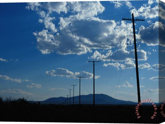 Raymond Gehman Silhouetted Telephone Poles Under Puffy Clouds Stretched Canvas Print / Canvas Art