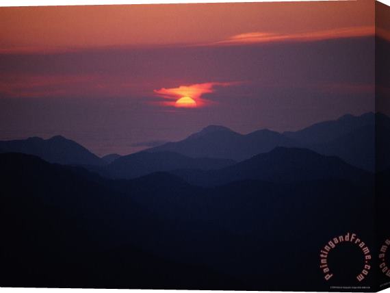 Raymond Gehman Sunrise Over a Silhouetted Range of Mountains Stretched Canvas Print / Canvas Art