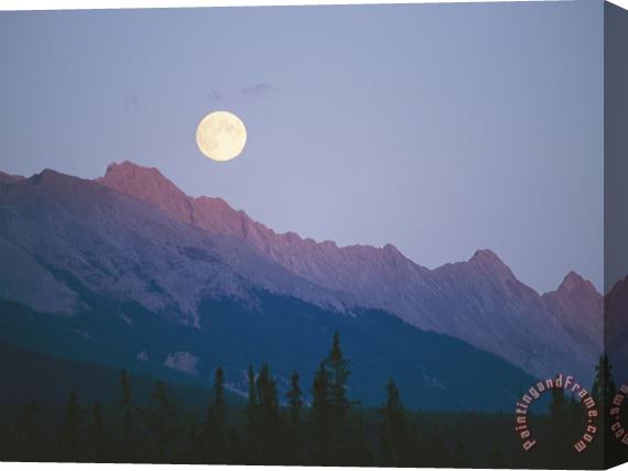 Raymond Gehman The Full Moon Over Mountains Lit by Low Sunlight Stretched Canvas Print / Canvas Art