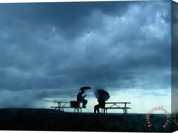Raymond Gehman Tourists Sit on Picnic Tables While Waiting Out a Storm Stretched Canvas Painting / Canvas Art